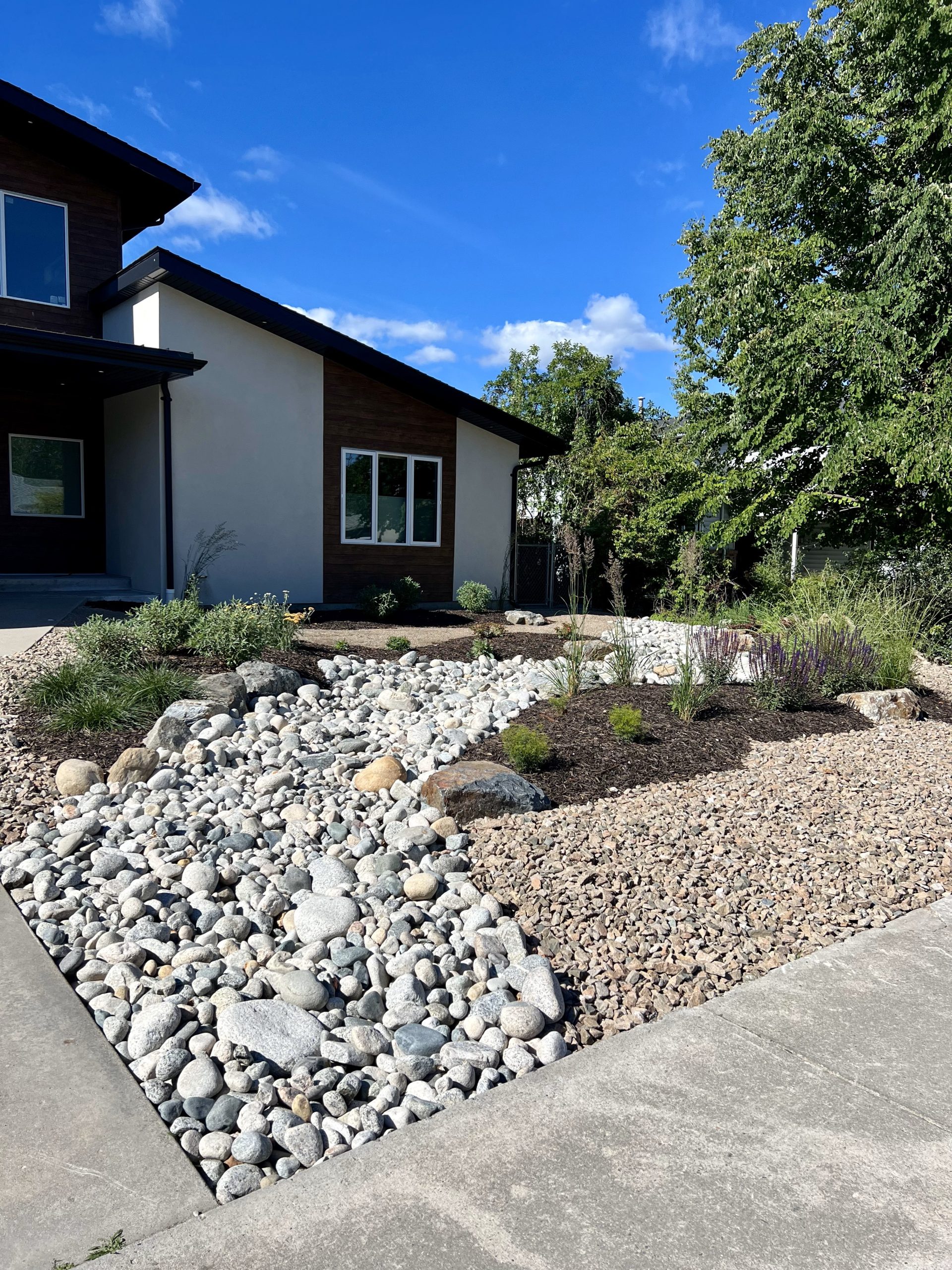 OK Valley river stone xeriscaping in front yard
